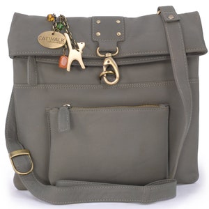 May include: A grey leather crossbody bag with a flap closure and a zipped pocket on the front. The bag has a decorative metal charm with a cat and the word "CATWALK" on it.