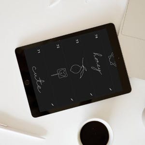 May include: A black iPad screen with white handwritten text and illustrations. The text includes "cute", "honey", and numbers 71-74. The illustrations include a heart on a stick, a lemon with a leaf, and a bird.