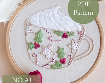May include: Embroidered hoop art depicting a coffee cup with whipped cream, holly, stars, and candy canes. The cup is adorned with green holly leaves, red berries, and white stars. The text "PDF Pattern" and "NO AI 100% human made" are also visible.