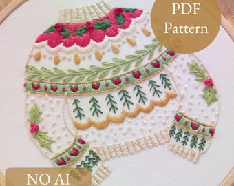 May include: Embroidered PDF pattern of a sweater design. The sweater is white with red, green, and gold floral and tree patterns. The text "PDF Pattern" is in a gold circle. The text "NO AI 100% human made" is in a gold rectangle.