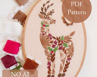 May include: An embroidered deer design in a wooden hoop. The deer is adorned with floral and leaf patterns in shades of brown, pink, and green. The text "PDF Pattern" and "NO AI 100% human made" are also visible.