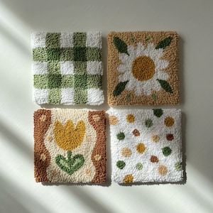 Coaster made with punch needle technique, with a floral pattern on it, dominated by green and brown tones