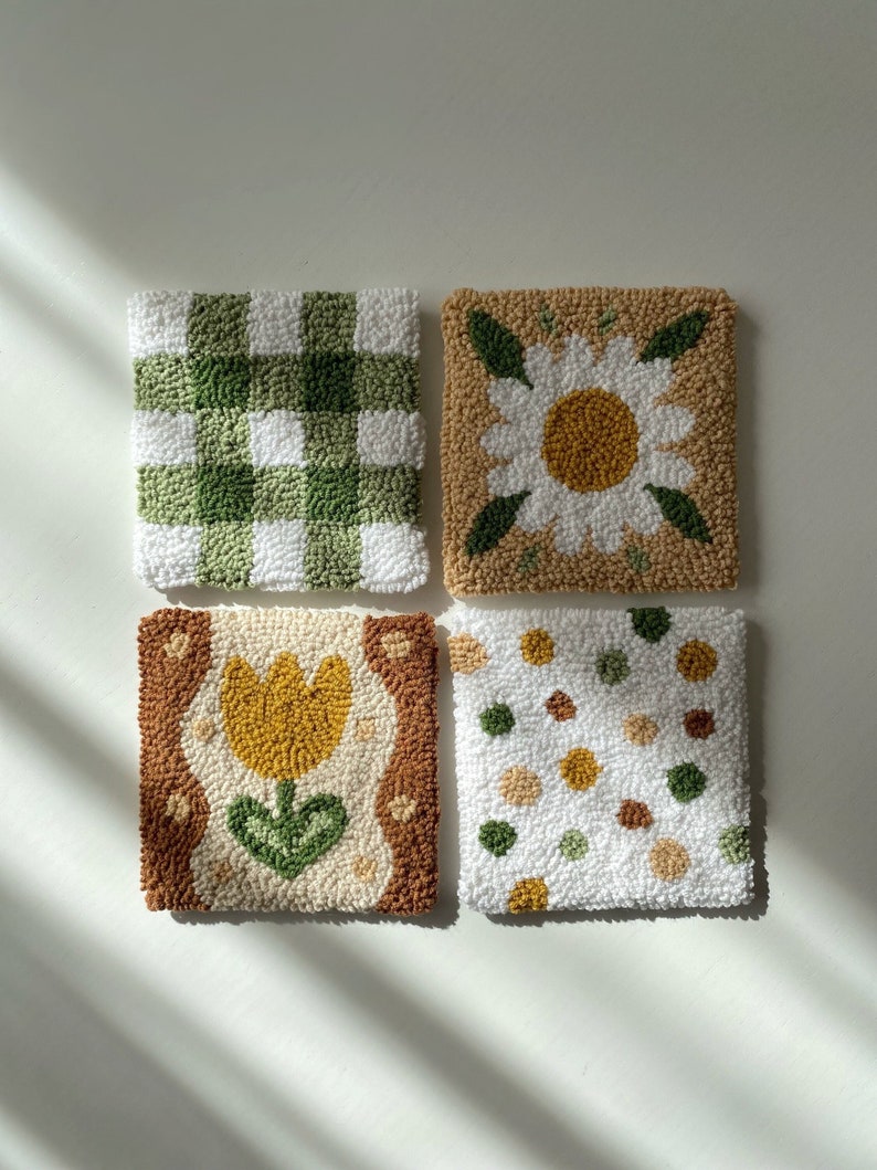 Coaster made with punch needle technique, with a floral pattern on it, dominated by green and brown tones