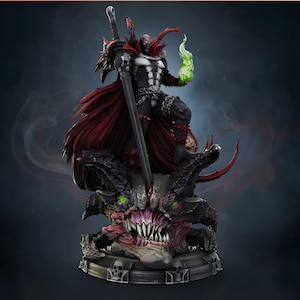 Pode incluir: Uma estátua colecionável detalhada de uma figura com armadura escura e uma longa capa vermelha, segurando uma grande espada cravada na cabeça de uma criatura com chifres e dentes afiados. A figura tem uma chama verde brilhante em uma mão.