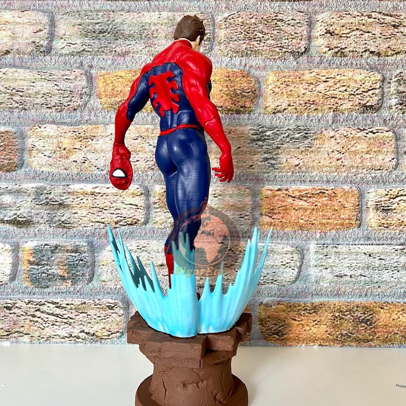 May include: A red and blue action figure of Spider-Man standing on a blue and brown base. The figure is posed with its back to the camera and its arms outstretched.