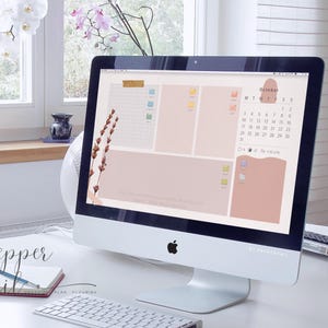 May include: A computer desktop with a pink and beige aesthetic. The desktop features a calendar for October, a to-do list, and a motivational quote. The computer is on a white desk with a keyboard and a notebook.