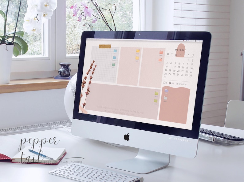 May include: A computer desktop with a pink and beige aesthetic. The desktop features a calendar for October, a to-do list, and a motivational quote. The computer is on a white desk with a keyboard and a notebook.