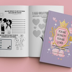 May include: A purple journal with a pink shield and gold crown. The shield has the text "You are Royalty! You are Loved!" and the text "A Girls Self Love Guided Journal & Coloring Activities" is below the shield. The journal is closed and the cover is visible.
