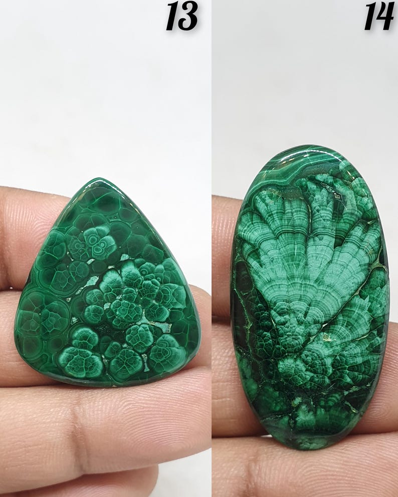 May include: Two polished malachite gemstones. The first is a triangular shape with a floral pattern. The second is an oval shape with a layered, fan-like pattern. Both stones are a deep, rich green color.