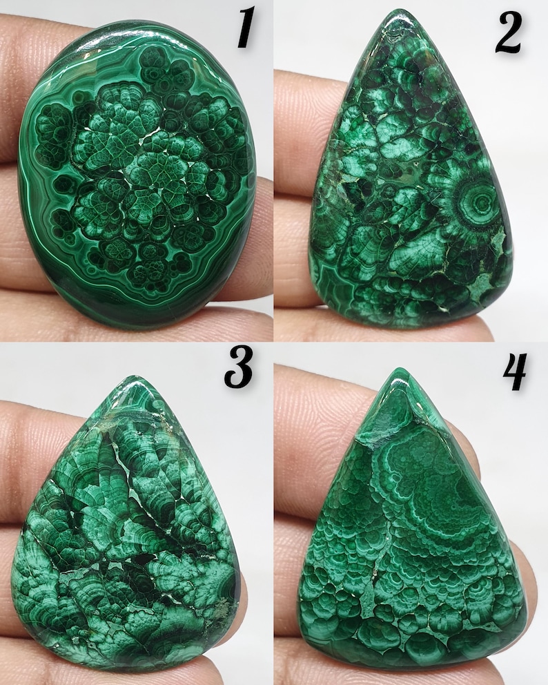 May include: Four polished malachite gemstones with unique patterns. The stones are numbered 1 through 4. The first is oval, the second is teardrop-shaped, the third is also teardrop-shaped, and the fourth is triangular.