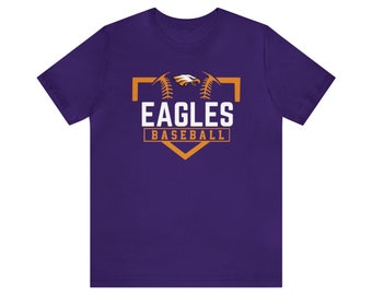 Puede incluir: Camiseta morada con la inscripción "EAGLES BASEBALL" en blanco y naranja. El diseño incluye un águila y un rombo de béisbol. La camiseta es de manga corta y cuello redondo.