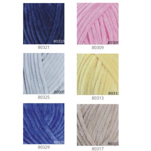 May include: Six skeins of yarn in different colors: navy blue, pink, light blue, yellow, blue, and beige. Each skein has a label with a number, for example, 80321.