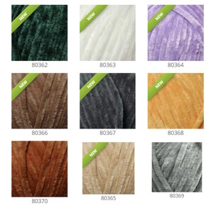 May include: Nine skeins of yarn in various colors, including green, white, purple, brown, gray, orange, rust, beige, and light gray. Each skein has a "NEW" tag attached.