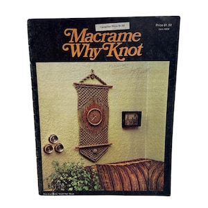 May include: A vintage book cover titled "Macrame Why Knot" with a black background and orange text. The cover features a macrame wall hanging with a clock, a small framed picture, and decorative wall accents.
