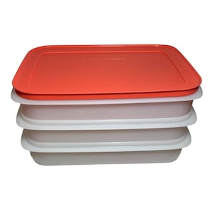 Puede incluir: Pila de recipientes rectangulares para guardar alimentos. La tapa superior es de color rojo brillante y los recipientes son blancos. Los recipientes son de plástico y están diseñados para mantener los alimentos frescos. Los recipientes están apilados.