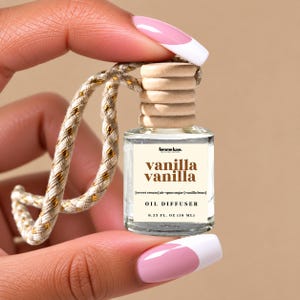 May include: A small clear glass oil diffuser bottle with a light wood cap and a braided beige and gold hanging cord. The label reads femme luxe, vanilla vanilla, sweet cream, air-spun sugar, vanilla bean, OIL DIFFUSER, 0.33 FL. OZ (10 ML).