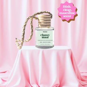 May include: A white ceramic mug with a black handle and the text "But First, Coffee" in a bold, black font. The mug is set against a neutral background, highlighting its simple design.