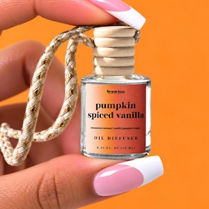 May include: A small clear glass oil diffuser bottle with a light wood cap and a braided gold and white hanging cord. The label reads femme luxe, pumpkin spiced vanilla, cinnamon, nutmeg, vanilla, pumpkin, sugar, OIL DIFFUSER, 0.33 FL. OZ (10 ML).