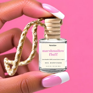 May include: A small clear glass oil diffuser bottle with a light wood cap and a gold-flecked hanging cord. The label reads femme luxe, marshmallow fluff, [marshmallow fluff | caramel | butter | sugar], OIL DIFFUSER, and 0.33 FL. OZ (10 ML).