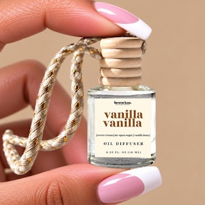 May include: A small clear glass oil diffuser bottle with a light wood cap and a braided beige and gold hanging cord. The label reads femme luxe, vanilla vanilla, sweet cream, air-spun sugar, vanilla bean, OIL DIFFUSER, and 0.33 FL. OZ (10 ML).