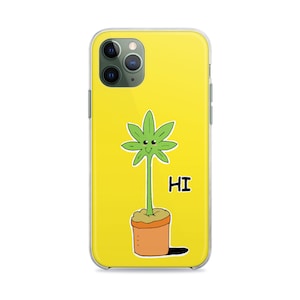 May include: A yellow phone case with a cartoon green plant with a smiling face and the word "HI" in black text.