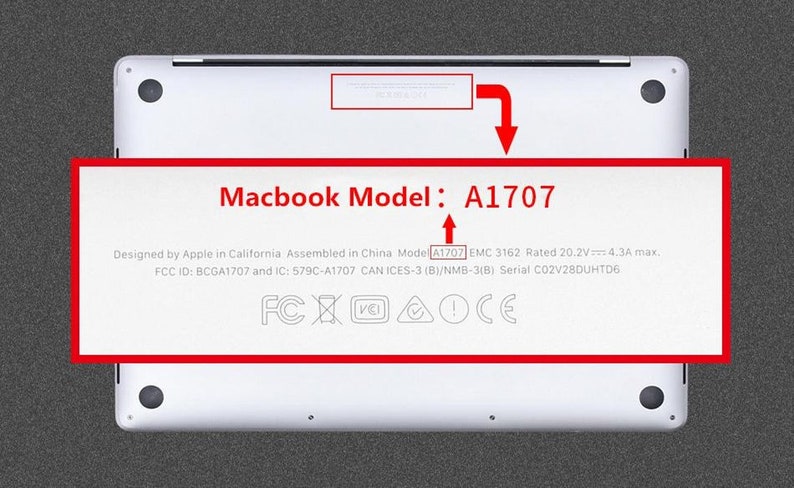 May include: Close-up of the bottom of a silver laptop with the text "Macbook Model: A1707" printed on the back. The text "Designed by Apple in California Assembled in China Model A1707 EMC 3162 Rated 20.2V 4.3A max. FCC ID: BCGA1707 and IC: 579C-A1707 CAN ICES-3 (B)/NMB-3(B) Serial C02V28DUHTD6" is also printed on the back. The laptop has the following certifications: FCX AOCE.
