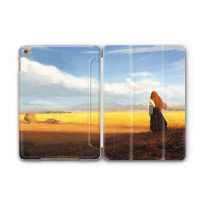 May include: A digital tablet case with a landscape image of a woman with long red hair standing in a field of yellow grass. The sky is blue with white clouds.