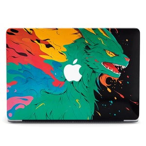 May include: A laptop skin with a colourful abstract design featuring a green creature with a fierce expression. The design includes splashes of red, yellow, blue, and black paint.
