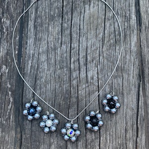 Beautiful dark silver bead flower pendant on silver necklace