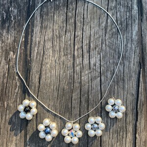 Beautiful white pearl bead flower pendant on silver necklace