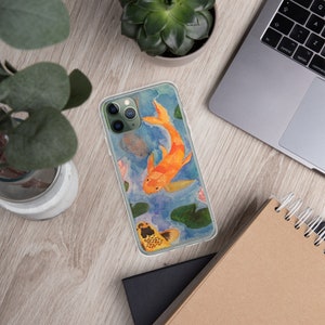 May include: A clear phone case with a watercolor design of two orange and yellow koi fish swimming in a pond with lily pads. The phone case is designed for an iPhone.