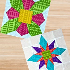 May include: Two colourful quilt blocks with floral and star designs. One block features a yellow centre, pink and green petals, and light blue corners. The other has a green centre, red, purple, and turquoise star points, and a white background.
