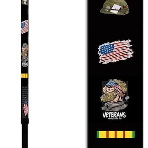 May include: A black walking stick with a design featuring a cartoon soldier, an American flag, and the text "Vietnam Veteran". The stick also features a yellow ribbon with the text "Veterans Never Give Up".