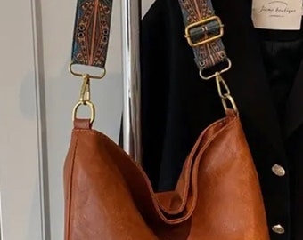 Tan leather shoulder bag with boho woven strap
