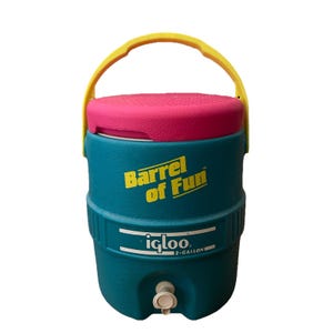 May include: A teal 7.5-litre Igloo water cooler with a pink lid and yellow handle. The words "Barrel of Fun" are printed in yellow on the front. A white spigot is located near the bottom.