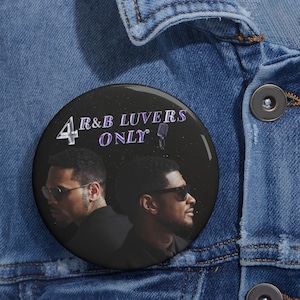 May include: A black badge with the text "4 R&B LUVERS ONLY" in white and purple. The badge features two men in profile wearing sunglasses. The badge is set against a denim jacket.