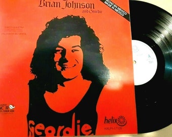 May include: A red vinyl record album cover with a black and white silhouette of Brian Johnson, the lead singer of the rock band AC/DC, with the text "Brian Johnson and Geordie" and "Made in Mexico" printed on the cover.