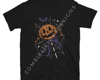 May include: Black t-shirt with a graphic of a jack-o'-lantern lollipop on a spiderweb. The lollipop has a purple bow and is on a stick.