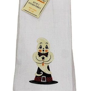 May include: A set of two white kitchen towels featuring a graphic of a ghost wearing a black hat with a red checkered band and a black bow tie, holding a star wand. The attached tag reads Johanna Parker Halloween, Set of 2 Kitchen Towels, 100% Cotton, 16" x 28".
