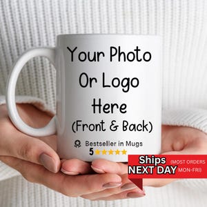May include: A white ceramic mug featuring the black printed text Your Photo Or Logo Here (Front & Back) followed by a small badge icon with the text Bestseller in Mugs and five yellow stars. The mug has a curved handle on the left side.