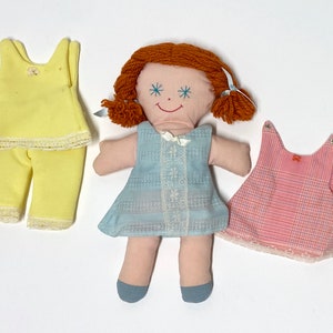 Vintage 1970s handmade rag doll with red hair and 3 outfits