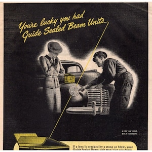 May include: A black and white vintage advertisement for Guide Sealed Beam Units. The ad features a man and a woman standing next to a car. The man is pointing at the car's headlight. The text in the ad reads "You're lucky you had Guide Sealed Beam Units".