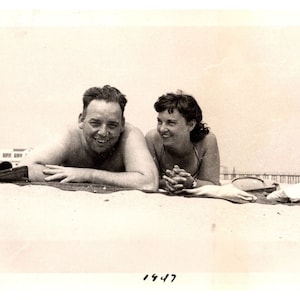 1947 Vintage Man and Woman Lying in the Sand on Beach Near Pier Photograph