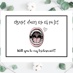 May include: A white card with black text that says "dzvst dwin es el pi sit" and a pink mouth with teeth. The card also says "Will you be my bridesmaid?"