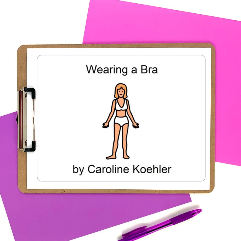 Puede incluir: Un portapapeles de madera contiene un papel blanco con el texto "Wearing a Bra" encima de una ilustraci&oacute;n de dibujos animados de una persona en sujetador y ropa interior. El texto "by Caroline Koehler" est&aacute; debajo. Un bol&iacute;grafo morado descansa sobre un fondo rosa y morado.