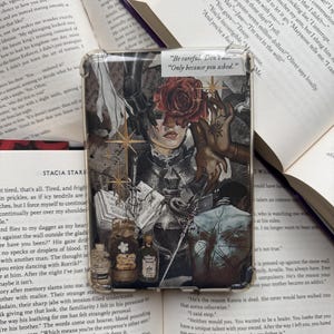 May include: A transparent phone case with a collage design. It features a woman's face, a rose, text, and bottles. The case has the text "Be careful. Don't die. Only because you asked."