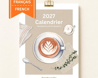 May include: A 2027 wall calendar titled 2027 Calendrier Une Année de Café en Aquarelle featuring a watercolor illustration of a coffee cup with latte art, a small spoon, a napkin, a creamer pitcher, and a green vine, held by a gold clip.