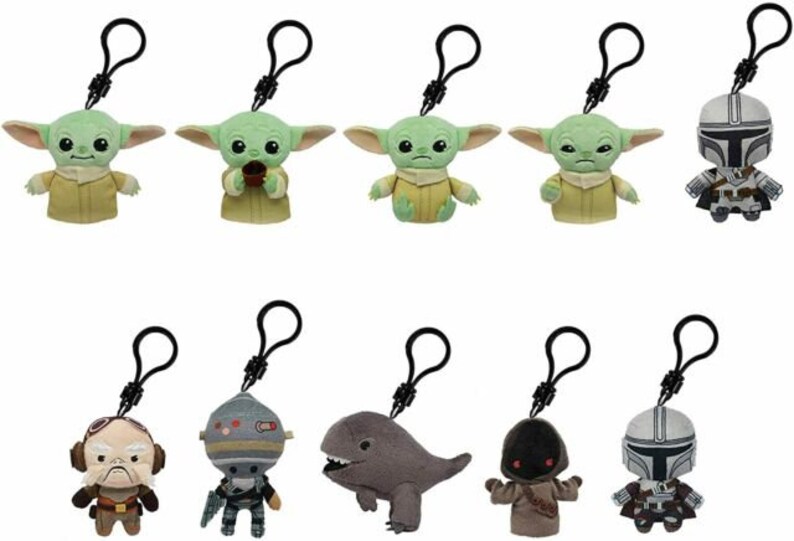May include: Ten plush keychain characters from the Star Wars franchise. The characters include The Mandalorian, Grogu, and a variety of other characters. The keychains are made of soft, plush fabric and have a black metal clip.