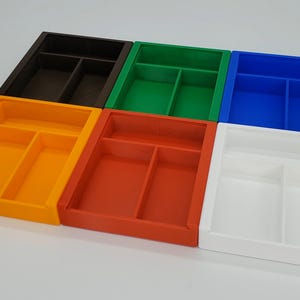 May include: Six plastic storage boxes with dividers. The boxes are in different colors: orange, red, green, blue, white, and brown.