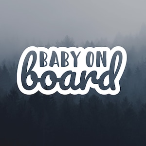 May include: A white sticker with the text "BABY ON board" in black lettering against a foggy forest background.